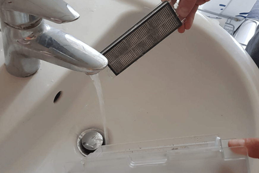 Cleaning the HEPA filter under running water